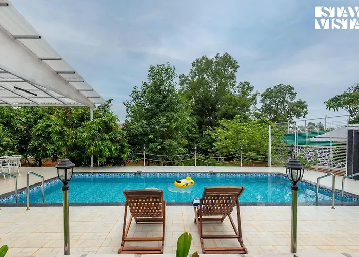 Grey Hues With Swimming Pool & Lawn At Karjat By Stayvista