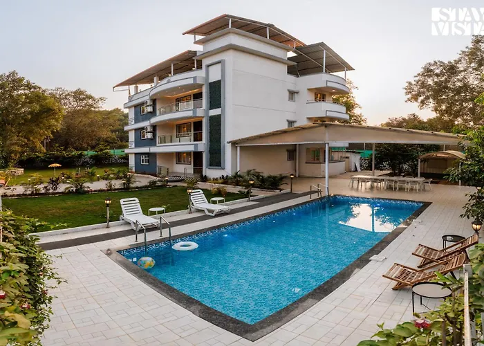 Grey Hues With Swimming Pool & Lawn At Karjat By Stayvista