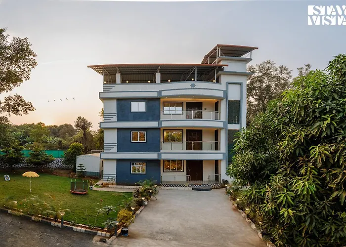Grey Hues With Swimming Pool & Lawn At Karjat By Stayvista